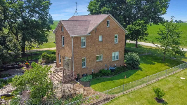 a front view of a house with a yard and outdoor seating