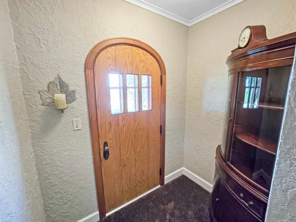 a view of an entryway with wooden floor and windows