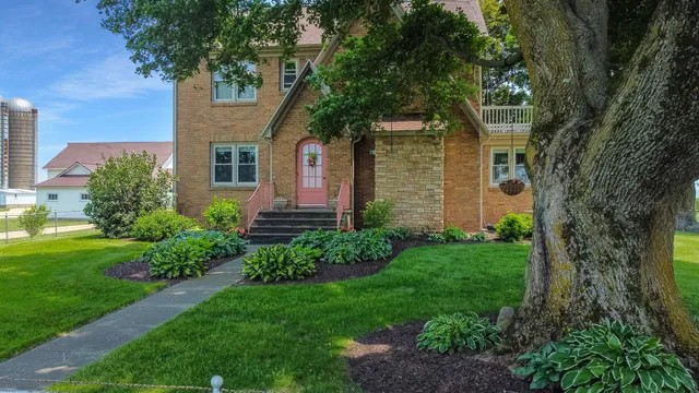 a view of a house with a yard and sitting area