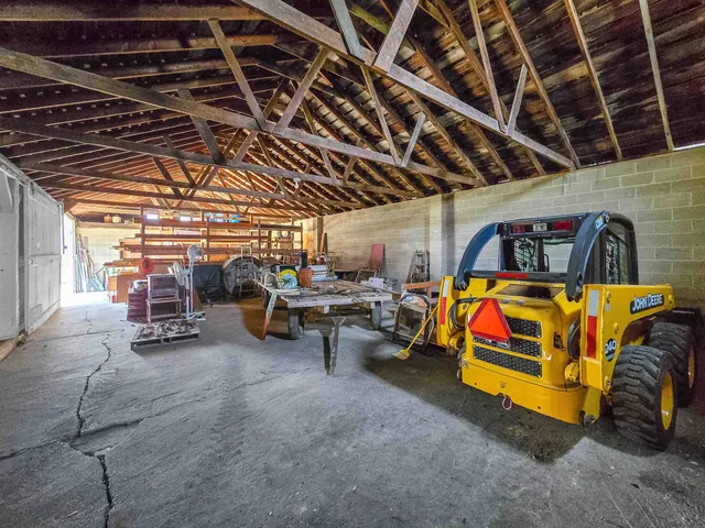 a view of a lake with a floor to ceiling window next to a yard