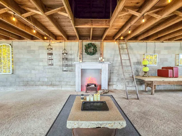 an aerial view of a house with garden space and outdoor seating