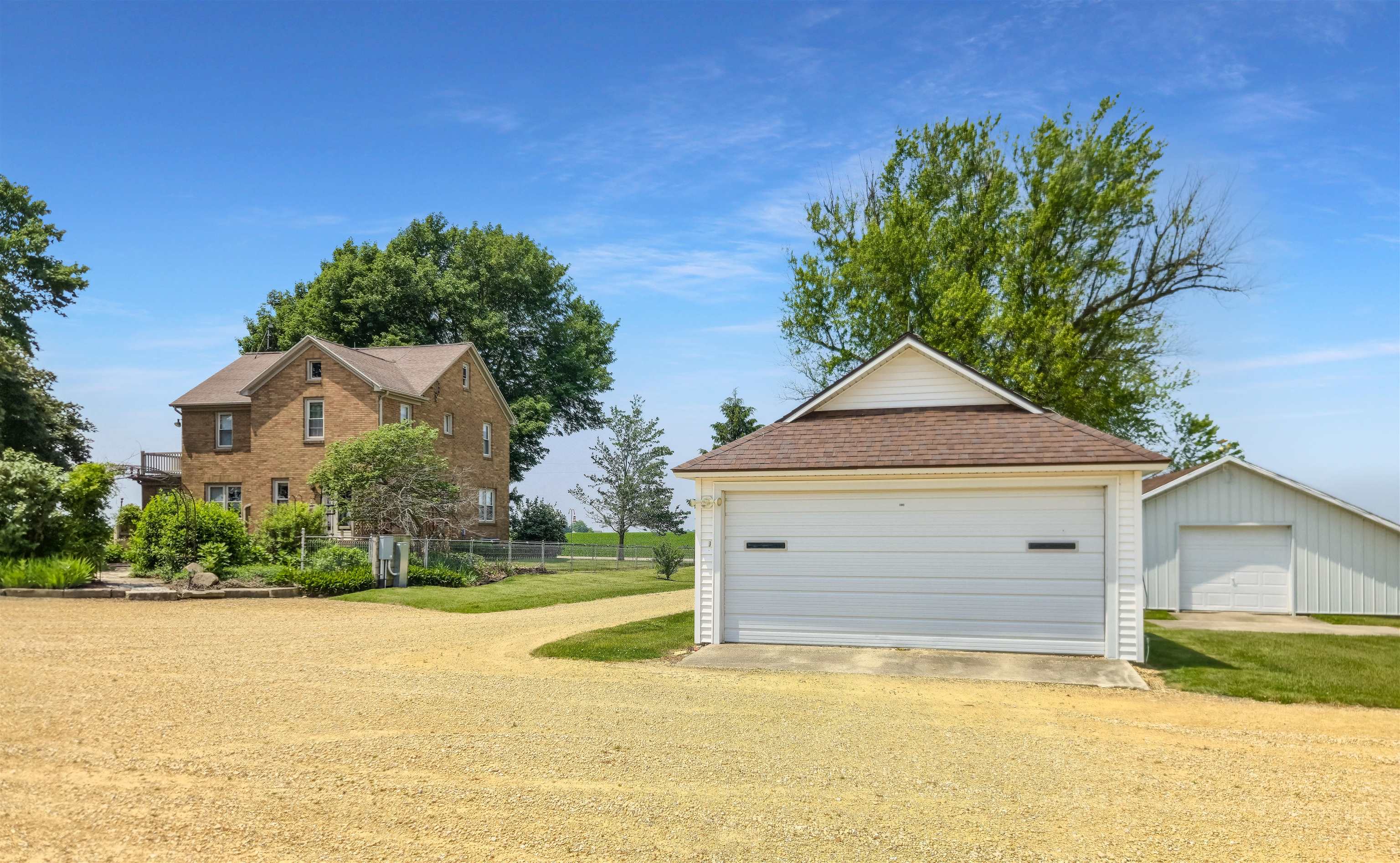 10225 North Brookville Road Shannon, IL 61078 - Photo 46 of 65 a front view of a house with a yard and garage