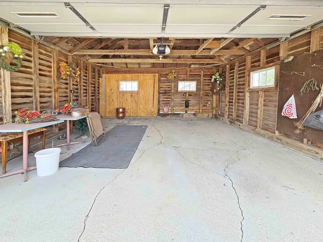 an aerial view of a house with a garden and lake view