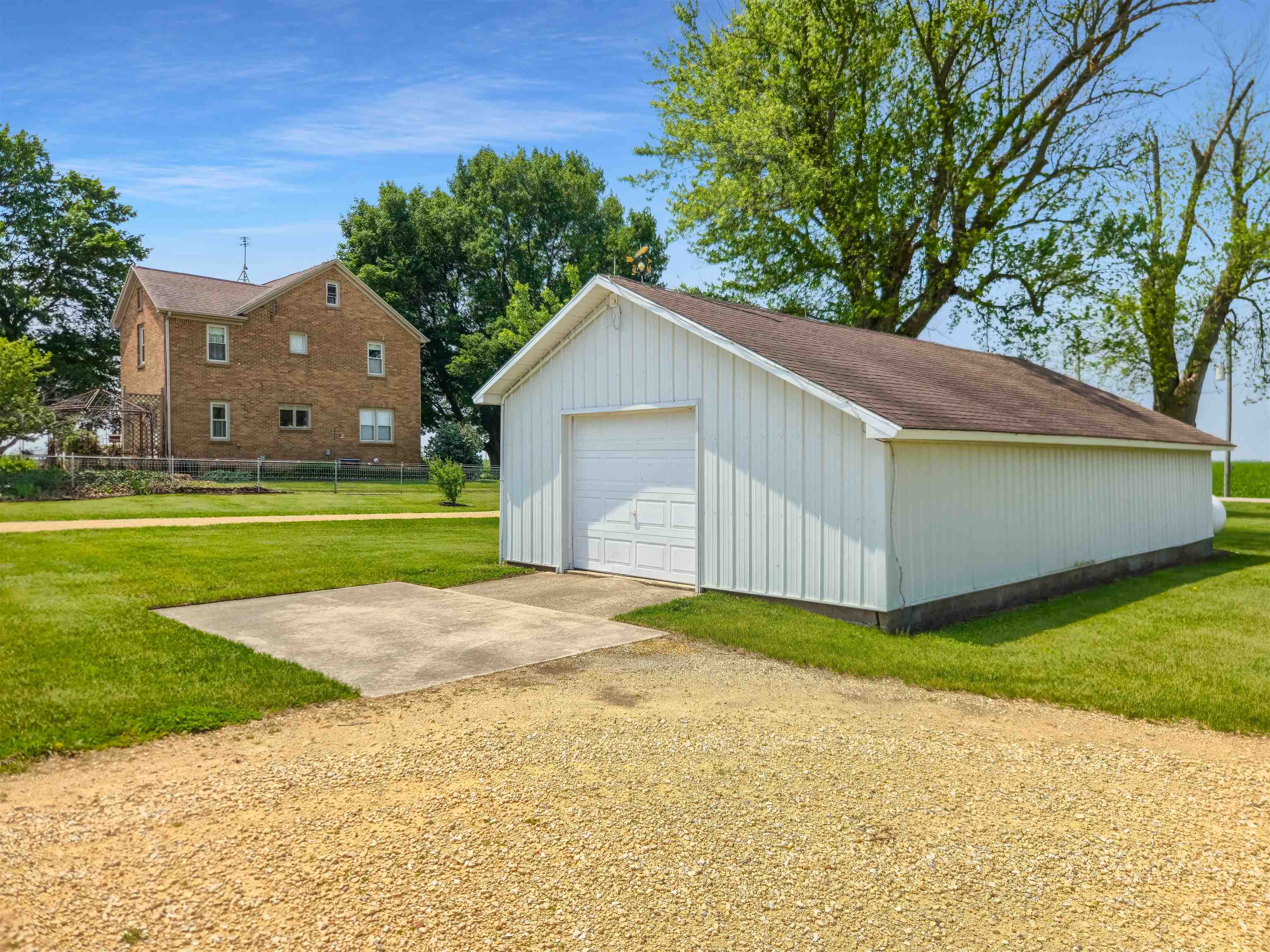 10225 North Brookville Road Shannon, IL 61078 - Photo 48 of 65 a front view of a house with a yard and garage