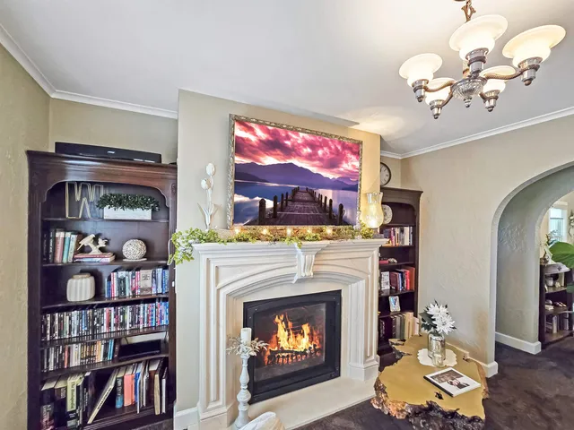 a living room with fireplace furniture and a flat screen tv