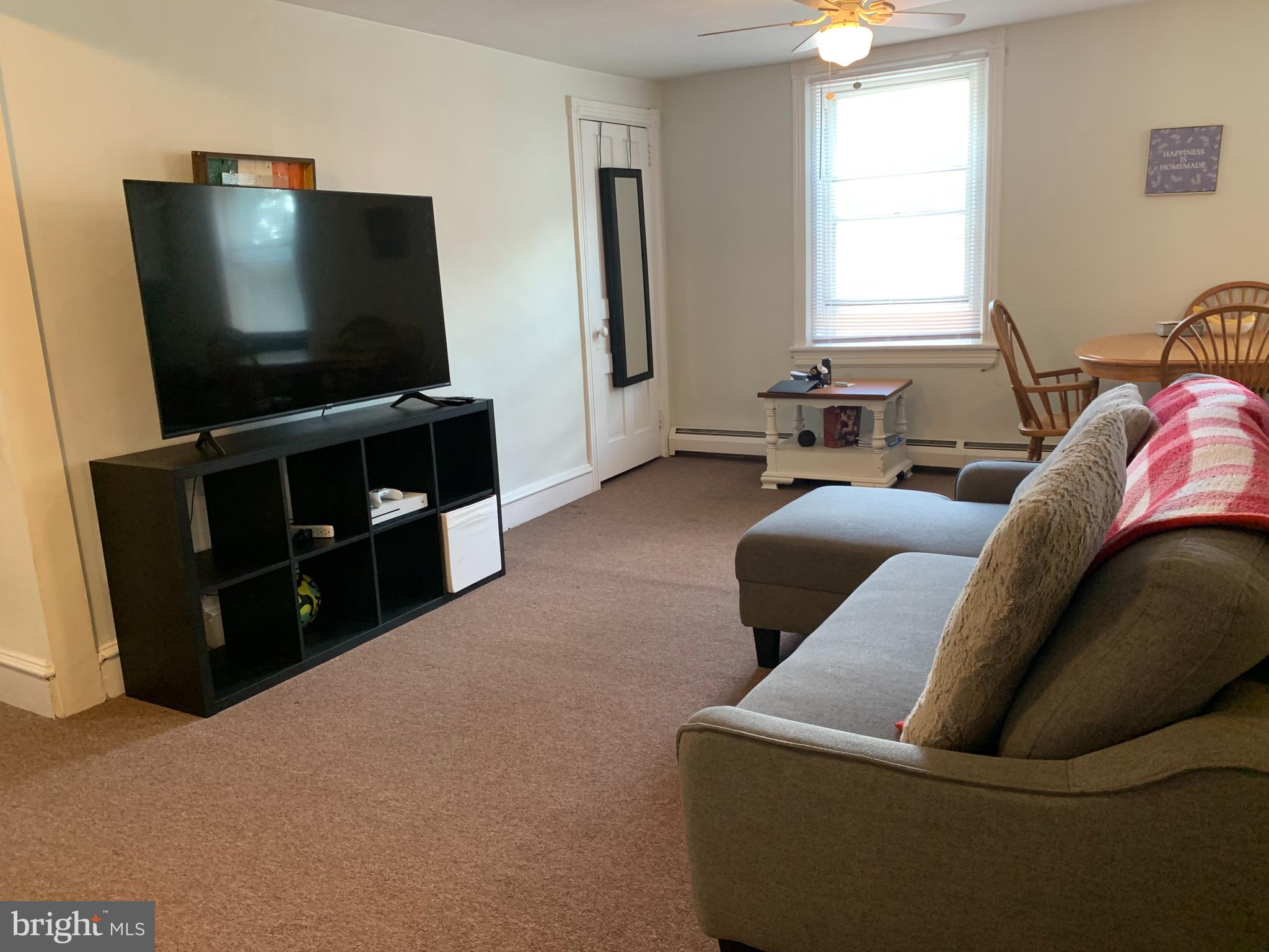 517 Walnut Street, Unit 3 Jenkintown, PA 19046 - Photo 5 of 16 a living room with furniture and a flat screen tv