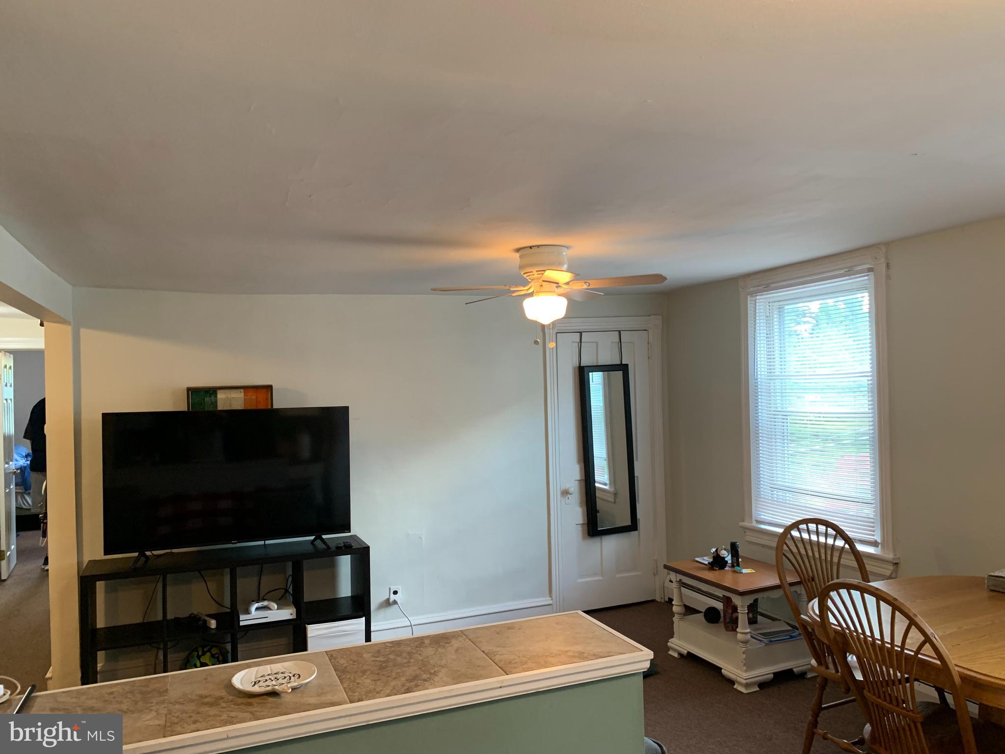 517 Walnut Street, Unit 3 Jenkintown, PA 19046 - Photo 6 of 16 a living room with furniture and a flat screen tv