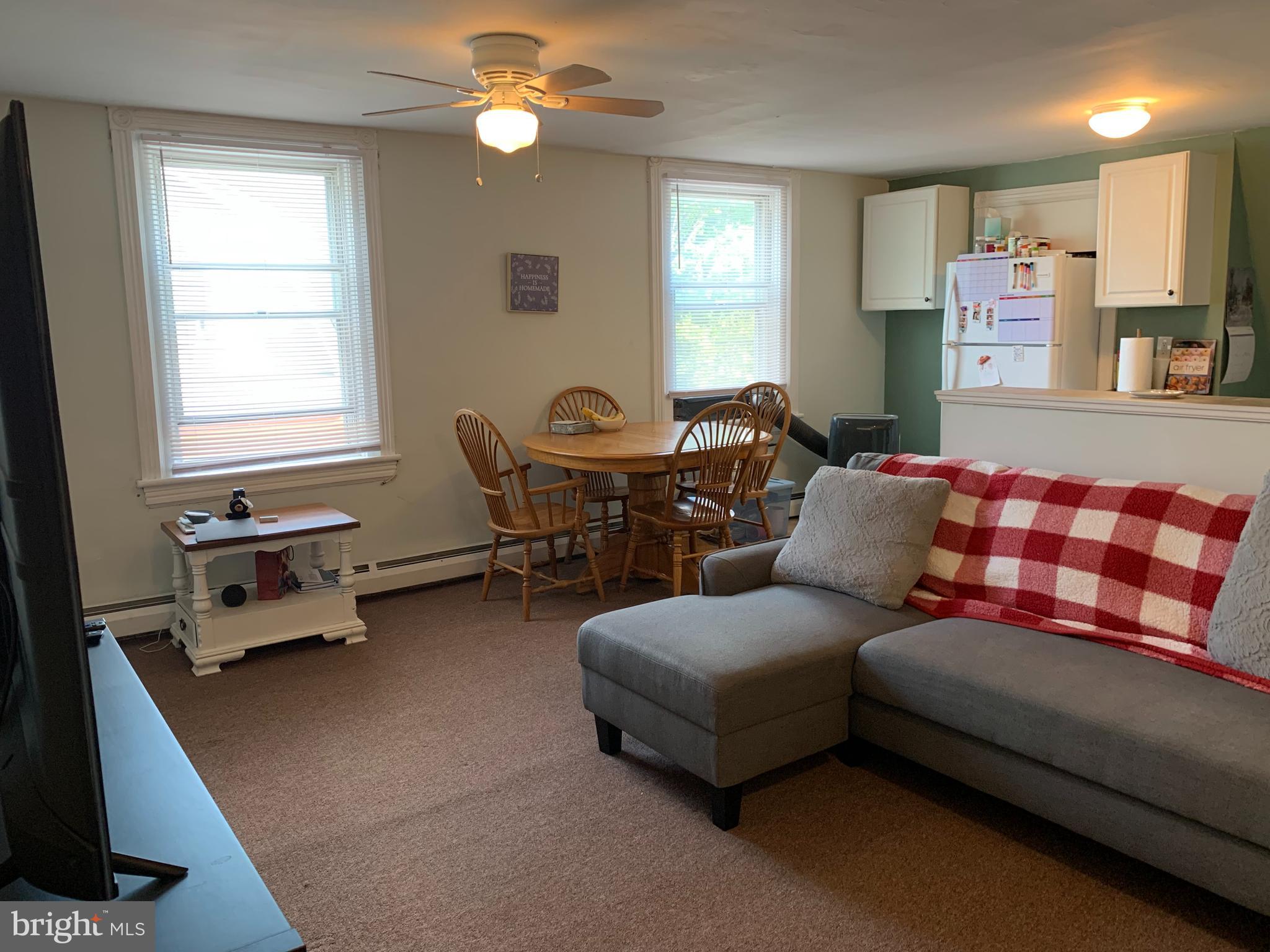 517 Walnut Street, Unit 3 Jenkintown, PA 19046 - Photo 7 of 16 a bedroom with a bed and a chandelier