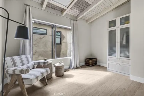 a bedroom with a large bed and a flat tv screen on dresser