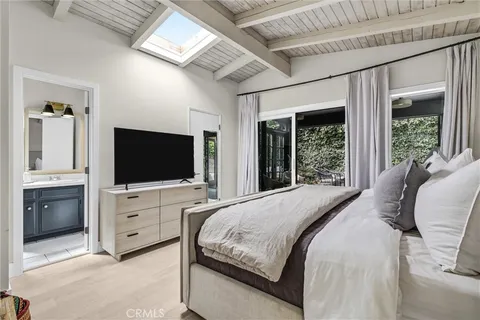 a bedroom with a large bed and a large window