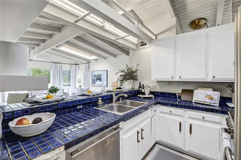 a kitchen with stainless steel appliances a sink and cabinets