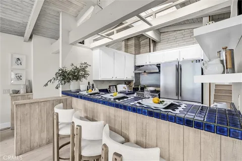 a dining table chairs in a kitchen and a kitchen view