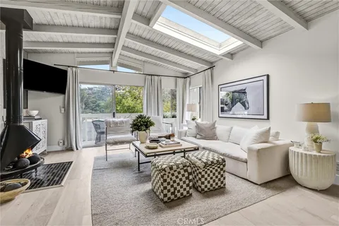 a living room with furniture ceiling fan and a window