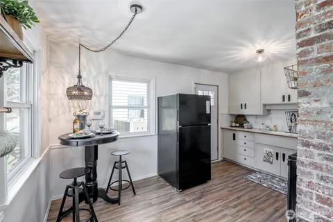 a kitchen with a refrigerator a sink and chairs
