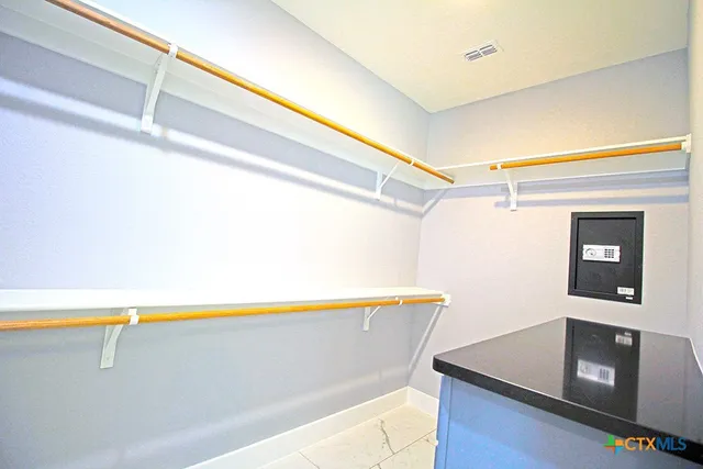 a room with a wooden floor and white wall