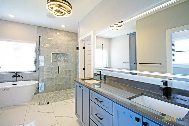 a bathroom with a tub sink and mirror