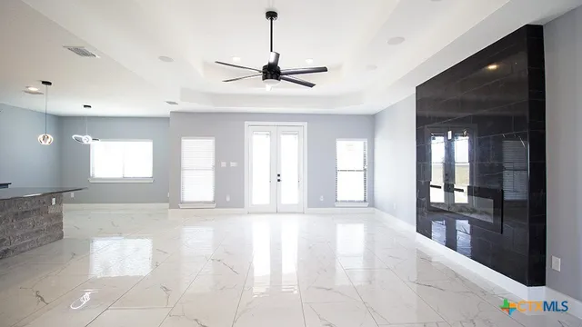 a view of an empty room window and wooden floor