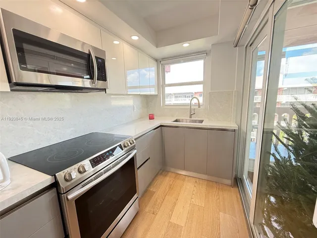 a kitchen with a sink stove and microwave