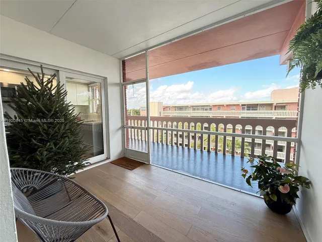 a balcony with furniture and flowers
