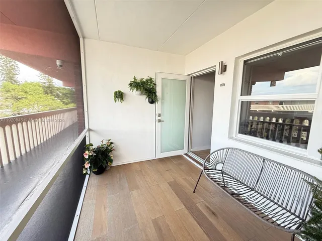 a view of an entryway with wooden floor