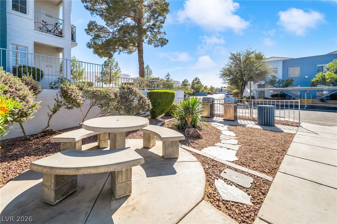 2201 Ramsgate Drive, Unit 811 Henderson, NV 89074 - Photo 32 of 36 A community gathering spot features a concrete picnic table and convenient barbecue grills, ideal for outdoor entertaining.