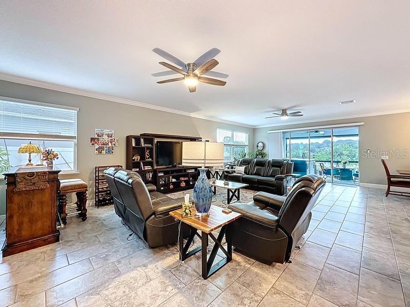10148 Florence Ridge Drive Clermont, FL 34711 - Photo 11 of 50 a living room with furniture a flat screen tv and a window