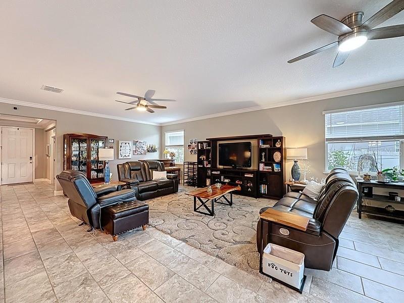 10148 Florence Ridge Drive Clermont, FL 34711 - Photo 12 of 50 a living room with furniture and a flat screen tv