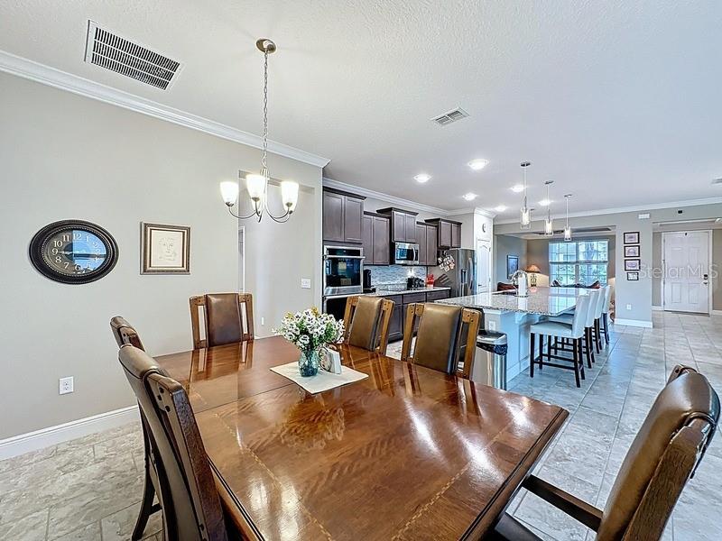 10148 Florence Ridge Drive Clermont, FL 34711 - Photo 16 of 50 a view of a dining room with furniture