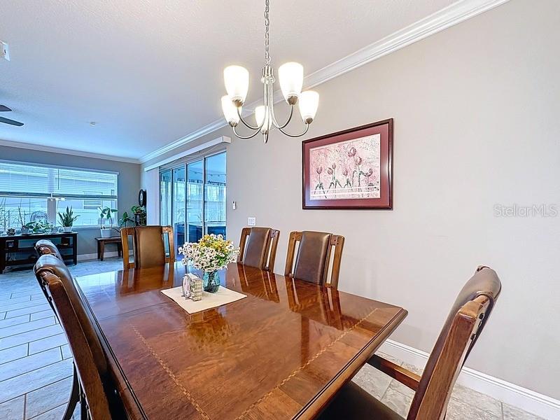 10148 Florence Ridge Drive Clermont, FL 34711 - Photo 18 of 47 a view of a dining room with furniture window and wooden floor