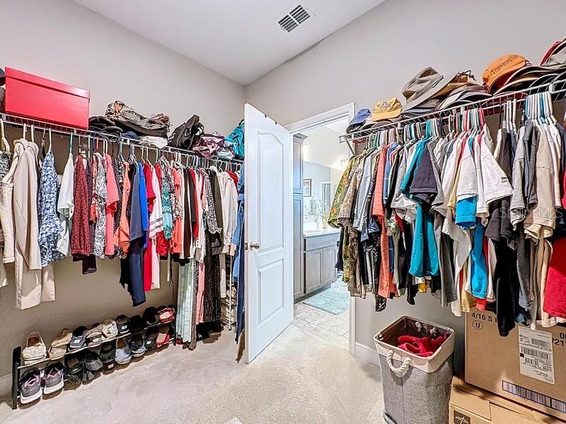 10148 Florence Ridge Drive Clermont, FL 34711 - Photo 25 of 50 a view of walk in closet with clothes