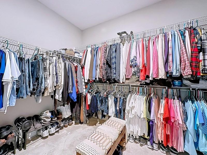 10148 Florence Ridge Drive Clermont, FL 34711 - Photo 26 of 50 a view of walk in closet with clothes