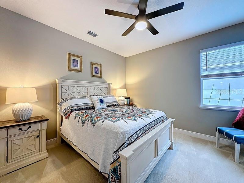 10148 Florence Ridge Drive Clermont, FL 34711 - Photo 28 of 47 a bedroom with a bed and a table in it