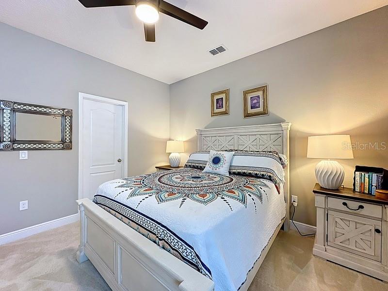 10148 Florence Ridge Drive Clermont, FL 34711 - Photo 29 of 47 a bedroom with a bed and furniture