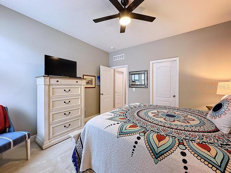 10148 Florence Ridge Drive Clermont, FL 34711 - Photo 29 of 50 a bedroom with a bed and a flat screen tv
