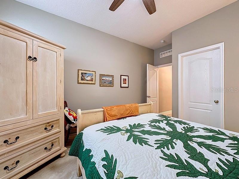 10148 Florence Ridge Drive Clermont, FL 34711 - Photo 32 of 47 a bedroom with a bed and closet with wooden floor