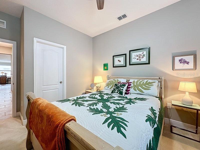 10148 Florence Ridge Drive Clermont, FL 34711 - Photo 33 of 47 a bedroom with a bed and paintings on the wall