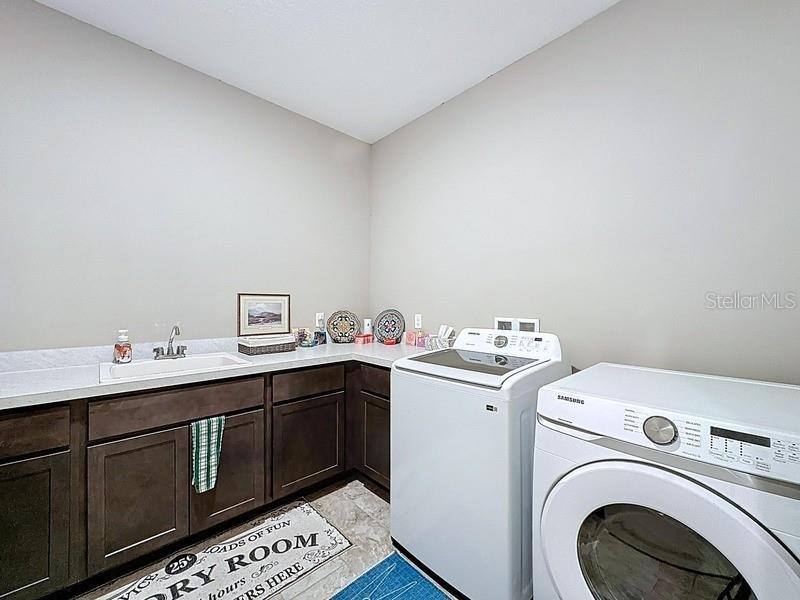 10148 Florence Ridge Drive Clermont, FL 34711 - Photo 37 of 47 a utility room with sink dryer and washer