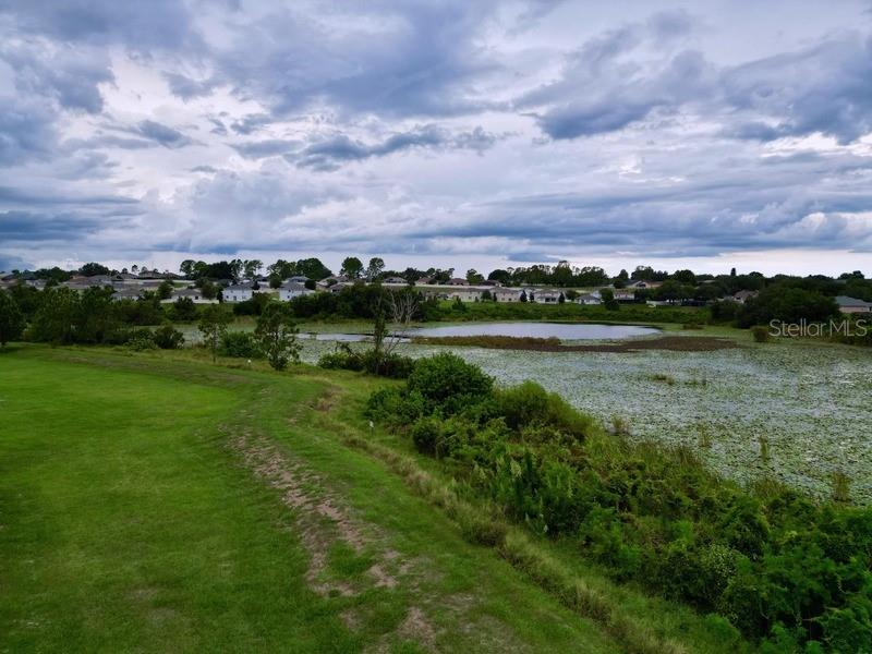 10148 Florence Ridge Drive Clermont, FL 34711 - Photo 41 of 47 a view of a lake with houses in the back