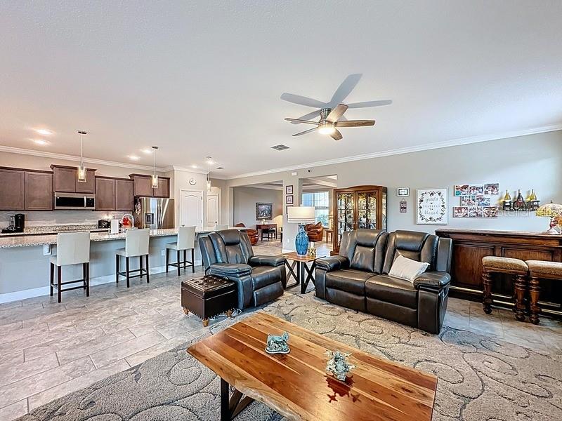 10148 Florence Ridge Drive Clermont, FL 34711 - Photo 8 of 47 a living room with furniture kitchen view and a wooden floor