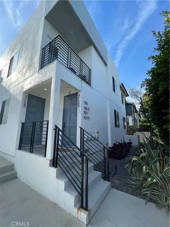 a view of a house with wooden fence