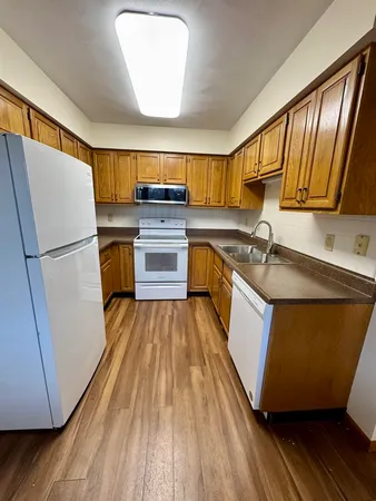 a kitchen with a sink and a refrigerator