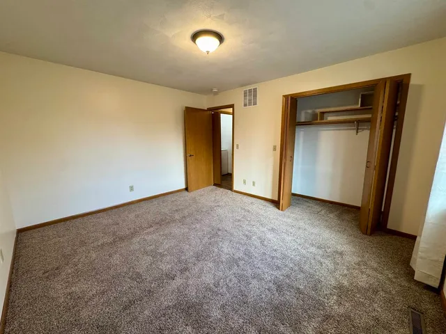 a view of an empty room and a window