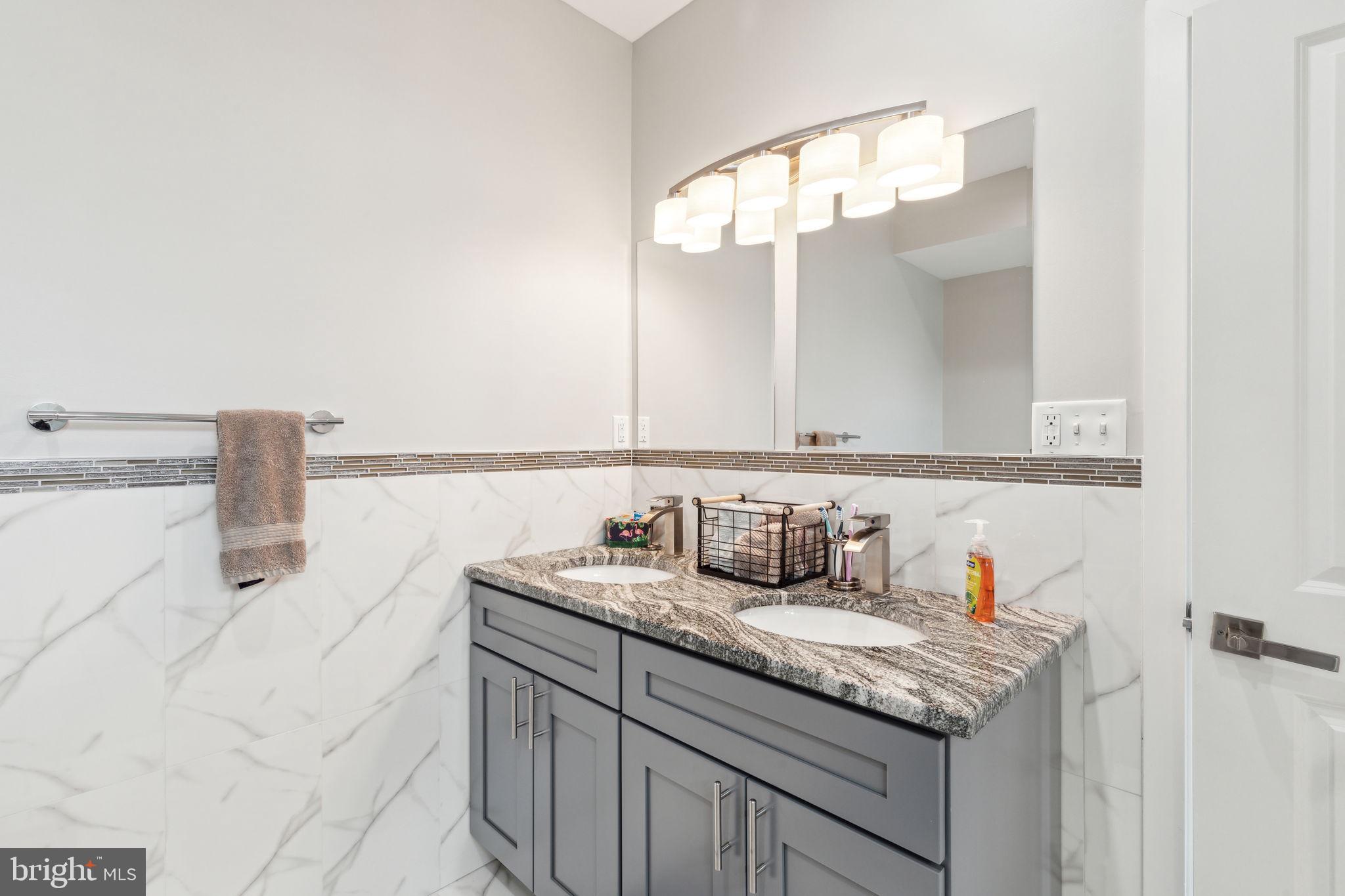 5301 Gainor Road Philadelphia, PA 19131 - Photo 26 of 51 a bathroom with a sink and a mirror