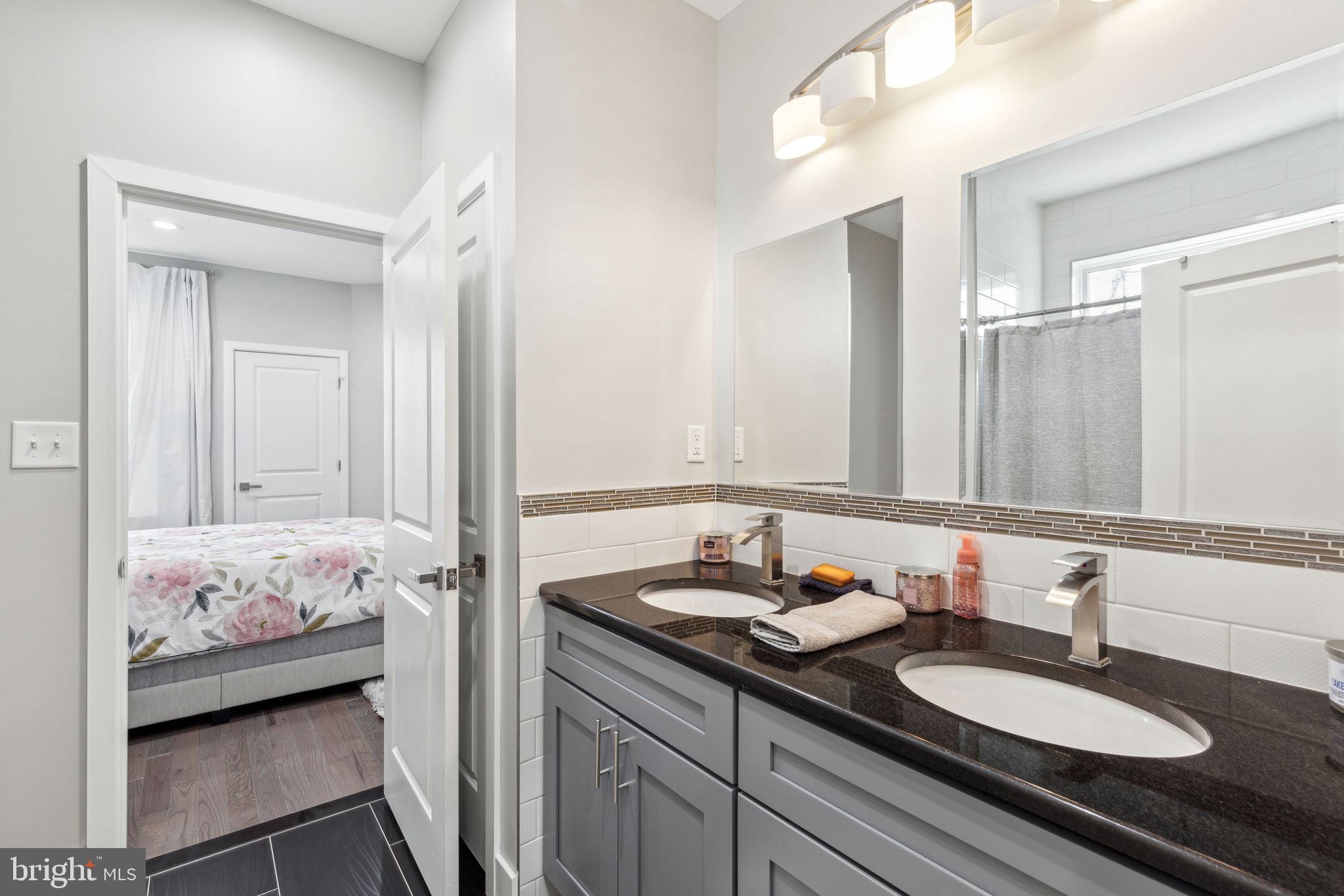 5301 Gainor Road Philadelphia, PA 19131 - Photo 33 of 51 a bathroom with a sink and a mirror