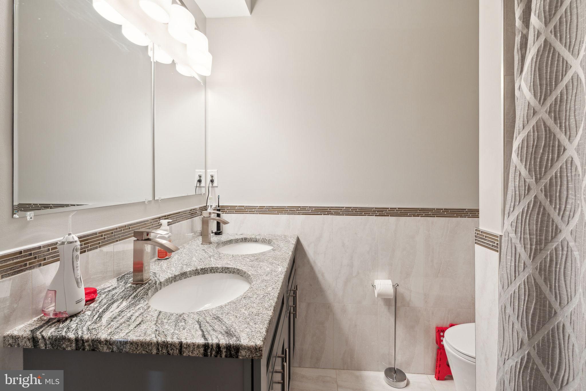 5301 Gainor Road Philadelphia, PA 19131 - Photo 37 of 51 a bathroom with a sink and a mirror