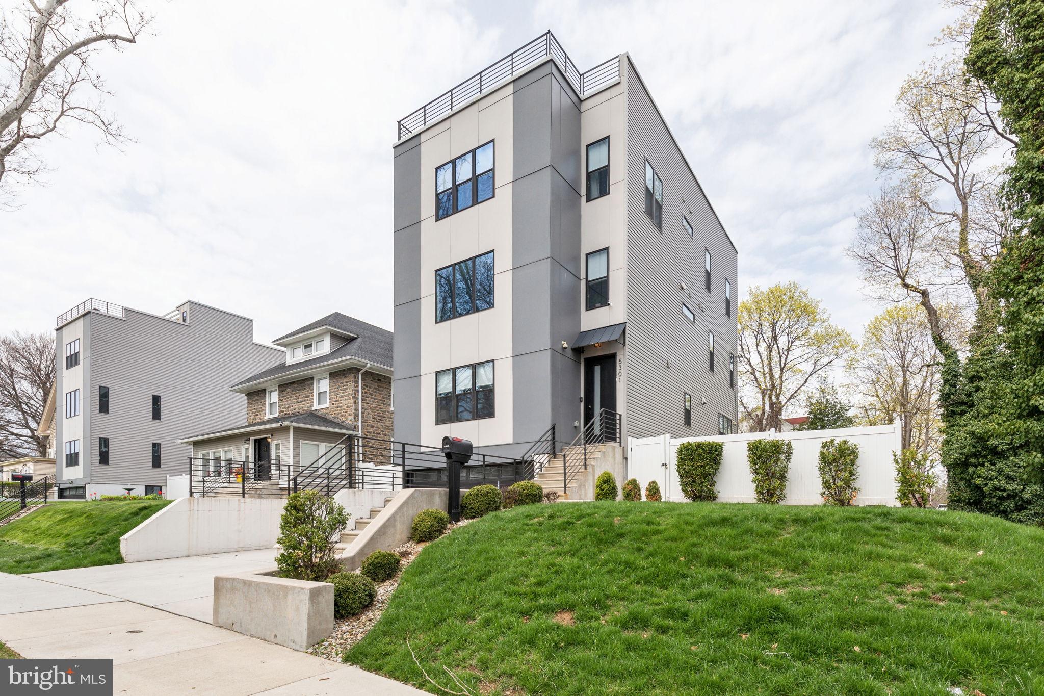 5301 Gainor Road Philadelphia, PA 19131 - Photo 51 of 51 a front view of a residential apartment building with a yard