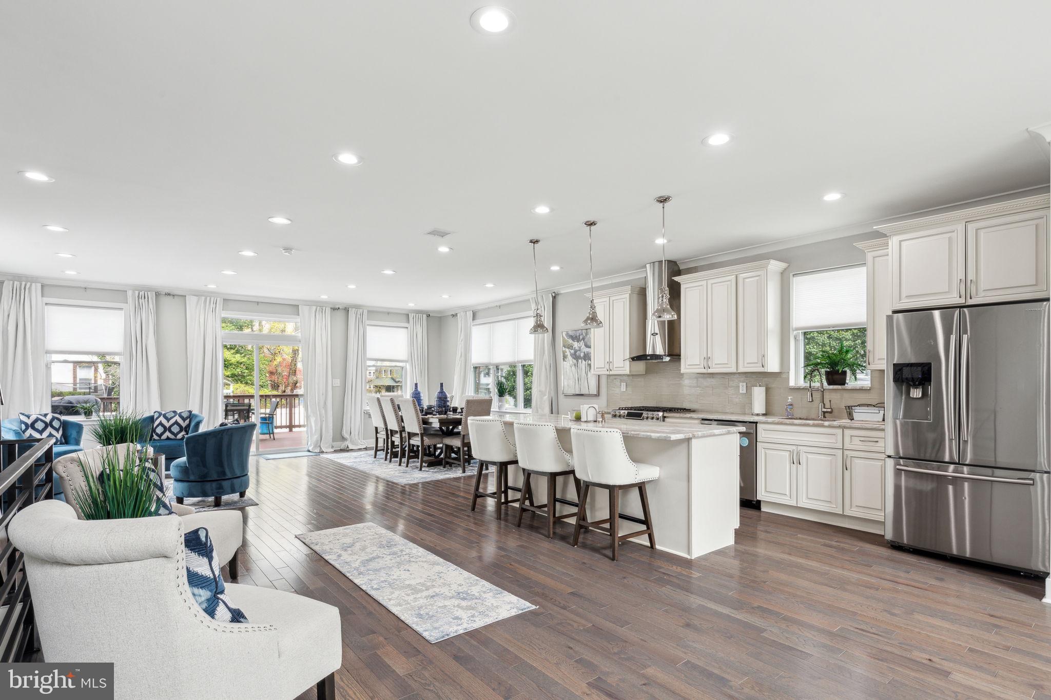 5301 Gainor Road Philadelphia, PA 19131 - Photo 7 of 51 an open kitchen with white cabinets and stainless steel appliances
