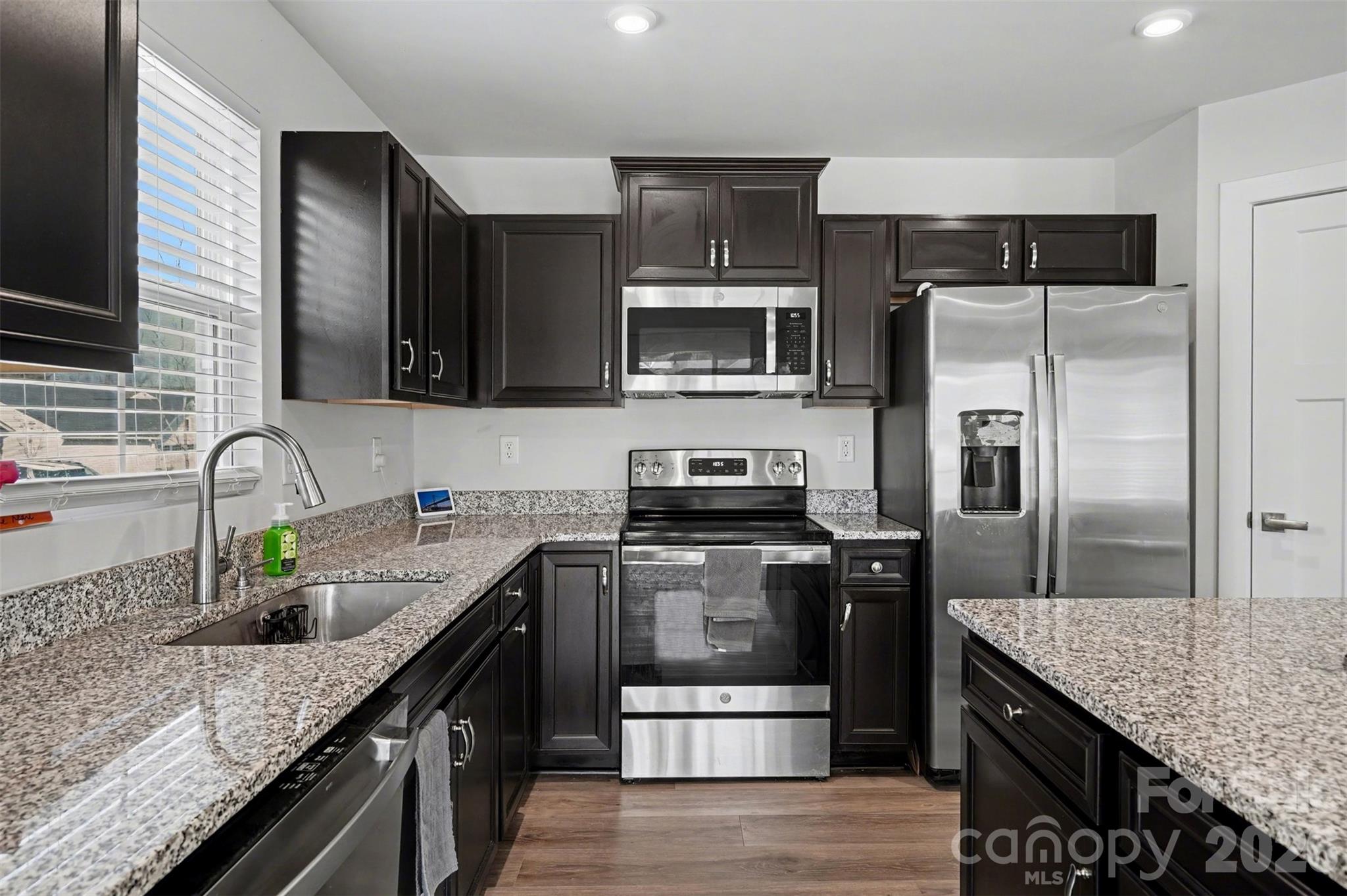 621 Grandiflora Avenue Lancaster, SC 29720 - Photo 15 of 37 a kitchen with kitchen island granite countertop stainless steel appliances and sink