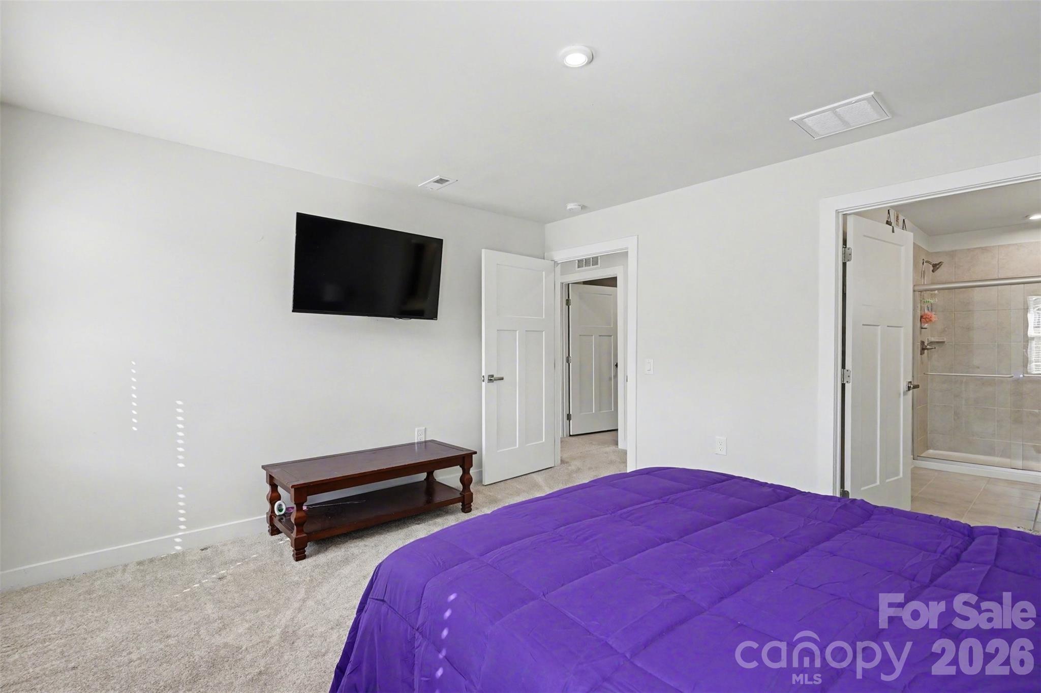 621 Grandiflora Avenue Lancaster, SC 29720 - Photo 20 of 37 a bedroom with a bed and a flat screen tv