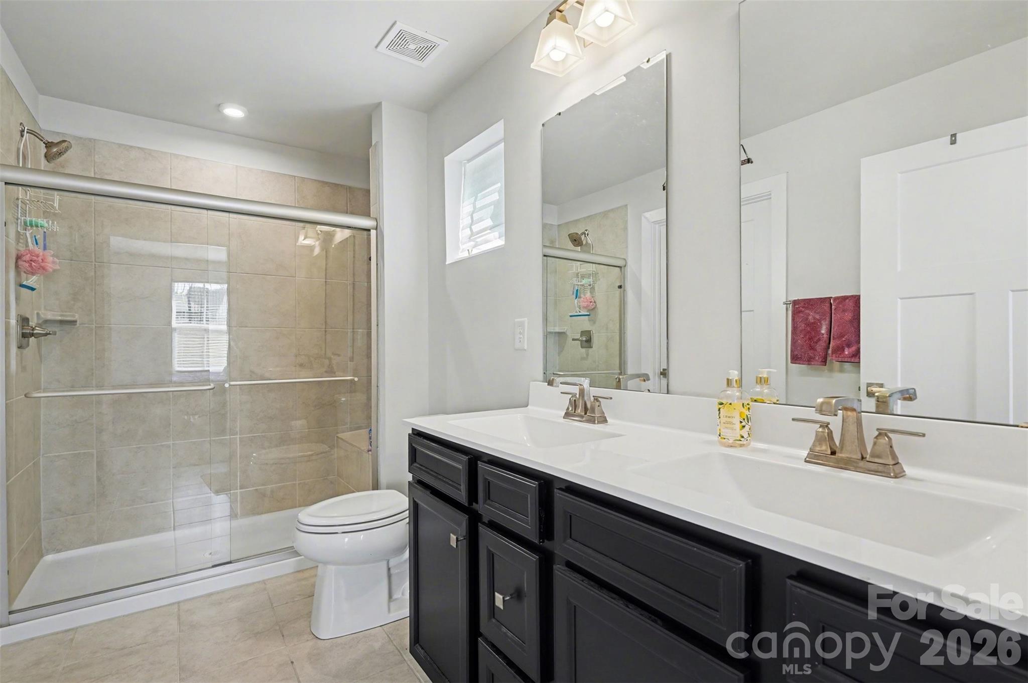 621 Grandiflora Avenue Lancaster, SC 29720 - Photo 21 of 37 a bathroom with a sink a toilet and shower